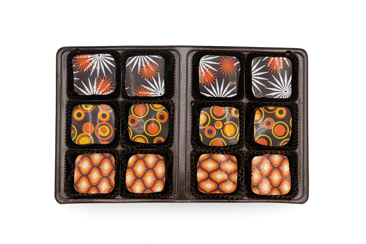 Assorted chocolates in a black box on a white background